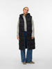 Person wearing a black puffer vest over a gray sweater on a white background
